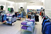 Fashion shop interior with display. Clothing in retail store.