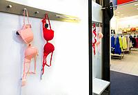 Woman`s underwear hanging in dressing cabin. Brassiere, bra, lingerie.