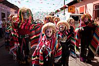Traditionally dressed mayan people wearing masks in the celebration of the feast day Our Lady of Guadalupe which is the patron saint of Americas, San ...