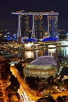 Aerial view of Marina Bay at night. In foreground The Esplanade theatre while in the background the tall towers of Marina Bay Sands. Singapore.