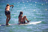Girls on surfboard paddling in the Mediterranean Sea, Benicassim, Castellon province, Comunidad Valenciana, Spain