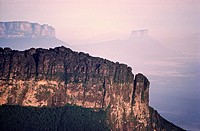 Aerial view of the Southeastern wall at sunrise of Aparaman-tepuy in tne Gran Sabana, Auyantepuy and Wei-tepuy in the background. Canaima National Par...