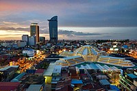 aerial view of the Art Deco Psar Thmei Central Market, Phnom Penh Tower, and city skyline, Phnom Penh, Cambodia.