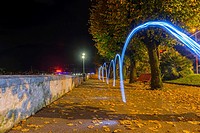 Light trails on the walkway in autumn at night in locarno ticino switzerland.
