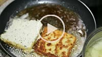 Breaded cheese frying on pan