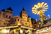 Cathedral of Trier and Christmas market with pyramid at night, Trier, Germany.