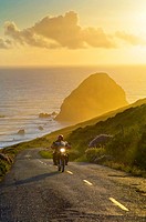 Motorcycle at sunset on the Mattole Road, at Cape Mendocino, on the Lost Coast, California.