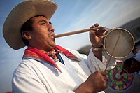 A Totonacan indigenous man plays flute and drums from Papantla, Veracruz, as part of the Dance of the Guaguas at the pilgrimage to Our Lady of Guadalu...