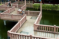 Zigzagging bridge crosses an ornamental lake at the Yu Bazaar, Shanghai, China. There is free access to this area, which is not a paid attraction.