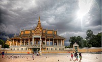 Royal Palace in Phnom Penh Cambodia under cloudy sky with sun.