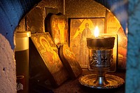 A lit candle and Icons inside a Religious Shrine ( Eklisaki ) Crete, Greece.