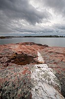 Incredible cloud formations and a White Quartzite strip running through Pink Granite covered in lichen along the shores of Georgian Bay in Killarney P...