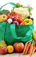 Green shopping bag with grocery products on white background.