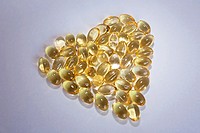 Cod liver oil Omega 3 gel capsules in the form of heart isolated on white background.
