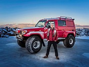 Man in front of a modified Jeep, Iceland.