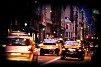 Traffic at street, taxis, night. Barcelona, Catalonia, Spain.