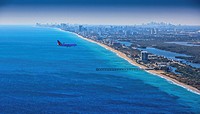 Jet airplane over Fort Lauderdale Beach