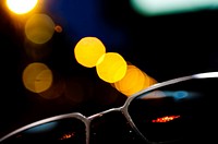 sunglasses with city lights background.