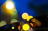 sunglasses with city lights background.