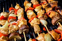 Chicken Shis kebab with mushrooms and peppers prepared over slow burning flame, barbecue style.