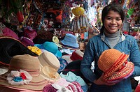 Hat seller at a Cambodian country market in Ratanakiri province.