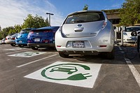 EV symbol painted on parking spaces for to plug-in electric cars in a company parking lot.