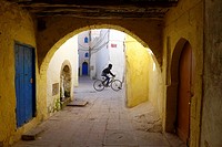 Morocco - Essaouira. Street scene with archway.