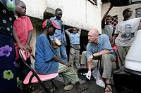 KENYA 2005. American volunteer missionary treating street children´s cuts and abrasions, Mombasa.
