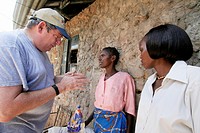 KENYA. American Catholic missionary visiting poor people with HIV AIDS, Mombasa.