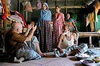 BANGLADESH. Americam Catholic missionary priest living in a village, Pouli, talking to locals.
