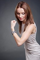 Studio portrait of a female office worker with strong biceps.