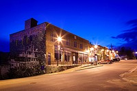 A strip of commercial buildings erected in 1932 with the ´Welcome to Port carling´ mural at dusk in downtown Port Carling, Ontario , Canada.