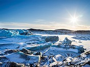 Svinafellsjoekull glacier in Vatnajoekull NP during Winter, view over the frozen glacial lake and the melting glacial front. europe, northern europe, ...