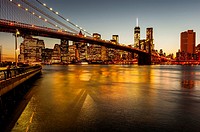 The Brooklyn Bridge, the East River and the Finanancial District with the new World Trade Center building , New York City at Sunset.