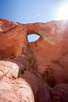 In a remote back country location in Monument Valley, a hole in the sandstone resembles an eye and is called Sun's Eye, as the sun shines brightly beh...