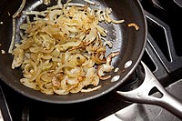 sautéed onions in a frying pan.