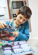 Young boy learning to cook, in the kitchen Valencia, Spain, .