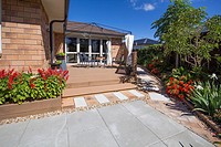 A patio on a deck with pavers and plants around in a back garden. New Zealand, Pukekohe, Auckland