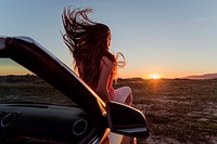 Young woman in a convertible car. Tarifa, Cadiz, Andalusia, Spain, Europe.