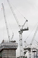 Several cranes on a construction site in Southwark, London Bridge, London, England, UK.