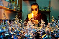 Glassblower makes glass figures of whirling dervishes in Mevlana Cultural Center, Konya, Turkey.