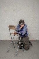 Man leaning on a chair.