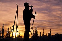 Backcountry skier silhouette at sunset, Hudson Bay Mountain, Smithers, British Columbia.