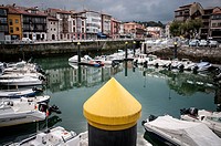 View of the port of Llanes with a yellow pile in the foreground. LLanes. Asturias. Spain.
