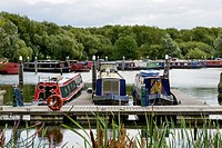 narrow boats at quay in Thames and Kennet Marina, Reading, view of quay at river harbour for narrow boats on river Thames, shot, under cloudy yet brig...