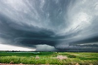High precipitation supercell storm tracks south of Hastings Nebraska June 15, 2009 as irrigation pivot waters the field ahead of the storm.