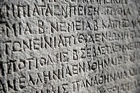Ancient greek inscription carved in stone. Greece, Central Greece, Sterea Ellada, Phocis, Ancient Delphi, listed as World Heritage by UNESCO.