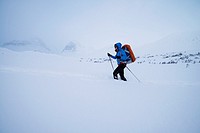 Female nordic ski tourer in deep snow near Kebnekaise Fjällstation, Lapland, Sweden.