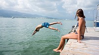 by jumping boy and girl watching sea, San Carlos de la Rapita, Tarragona