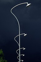 Abstract image of street lamps against a stormy sky.